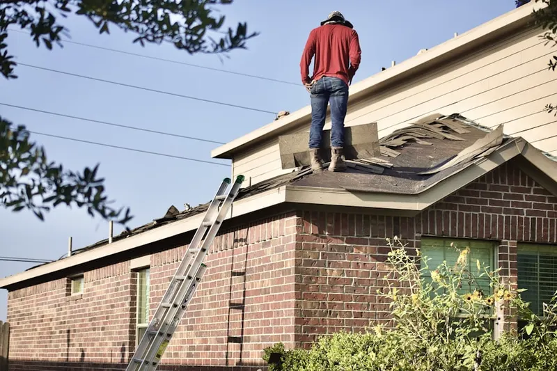 Professional roofer working on a residential roof in Sendera Ranch